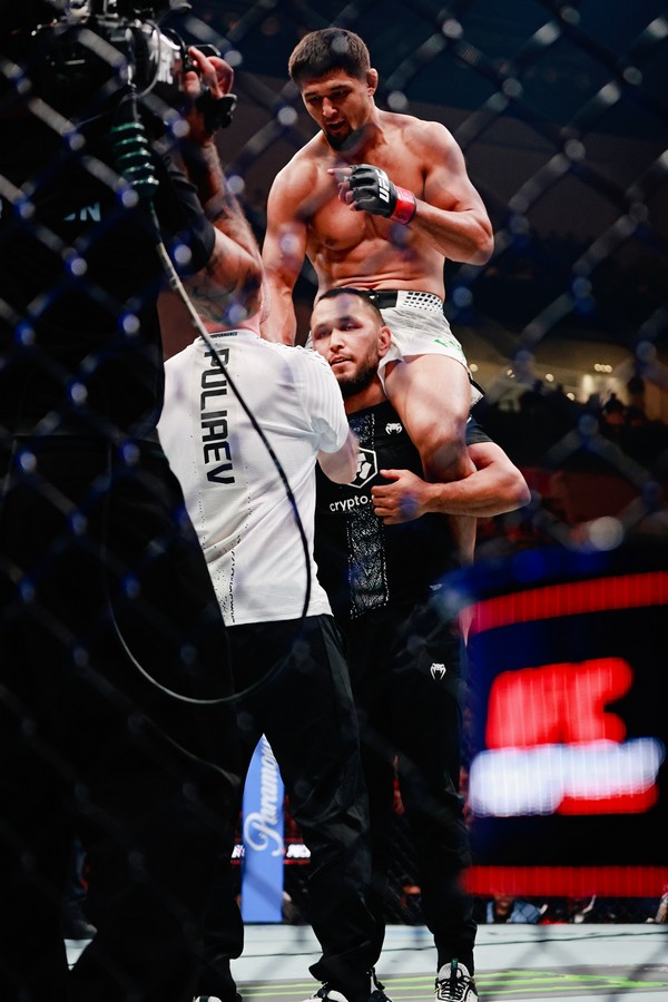 After defeating Andrey Pulyaev with Technical Submission, Nursulton Ruziboev in on shoulders on his team member after winner announcement inside the octagon