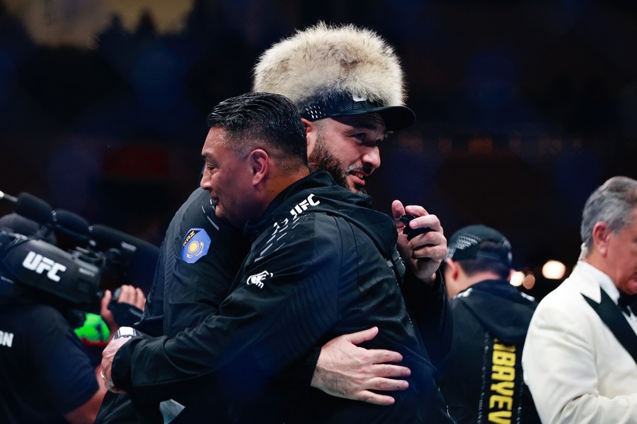 The members from Asu Almabayev and Charles Johnson are hugging each other