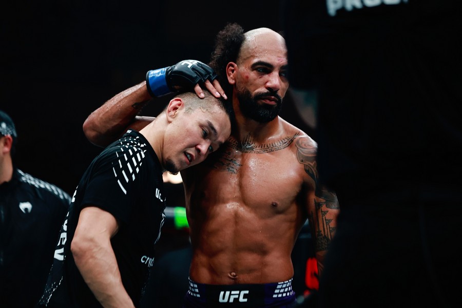 Charles Johnson tries to hug by pressing Asu Almabaev head onto his shoulders