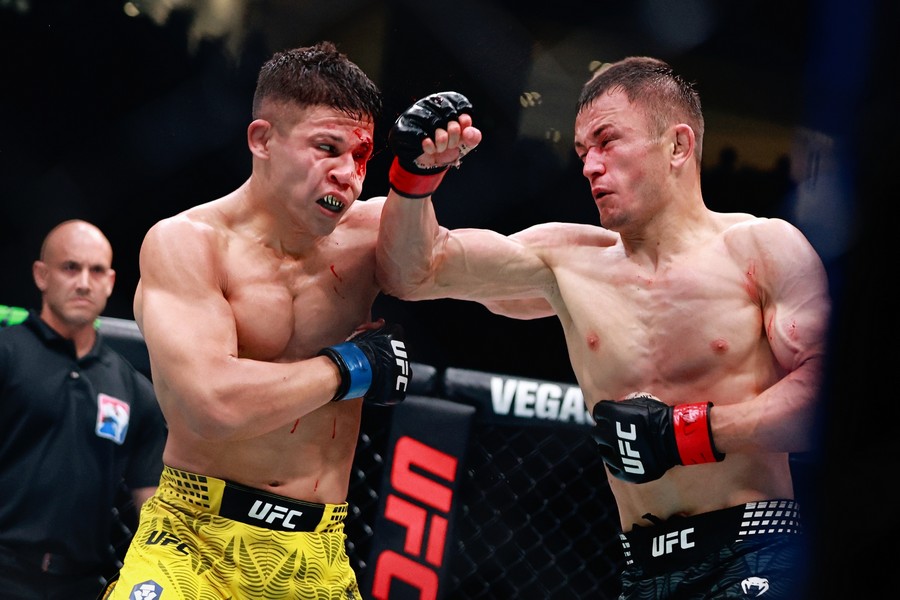 A moment after Bekzat Almakhan lands a face kick to Jean Matsumoto